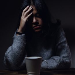 anxious person sitting in the dark 