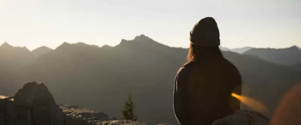person watching sunrise over mountain